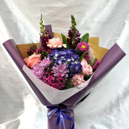 Close up of violet hydrangea and burgundy snapdragons on Damson Hour by Magic Blooming